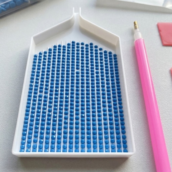 Round diamond painting drills in a diamond painting tray